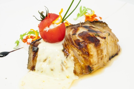 Roasted fillet of grilled fish in a white sauceの写真素材