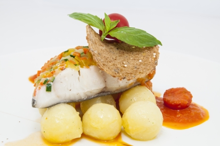 baked fish with potatoes in tomato sauceの写真素材