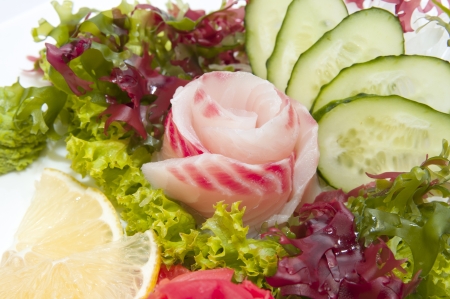 Japanese cuisine sashimi with vegetables and fish in a restaurantの写真素材