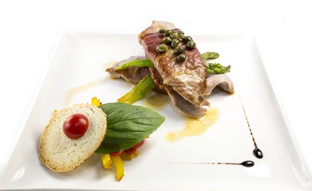 baked meat with asparagus on a white background in the restaurantの写真素材