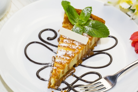 a piece of cheese cake on a table in a restaurantの写真素材