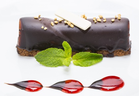 a piece of cream cake decorated with chocolate and mintの写真素材