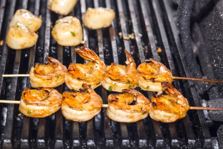 cooking shrimp on the grill in the restaurantの写真素材