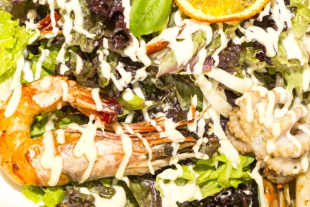 salad with vegetables and seafood on the table in a restaurantの写真素材