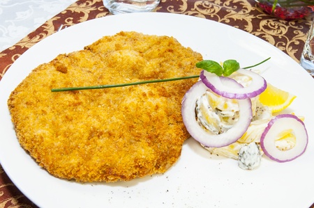 Schnitzel vegetable salad at restaurantの写真素材