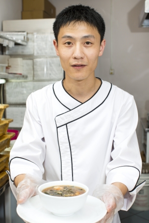 Japanese chef with a plate of sushiの写真素材