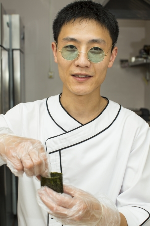 Japanese chef with a plate of sushiの写真素材