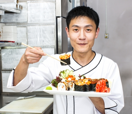 Japanese chef with a plate of sushiの写真素材