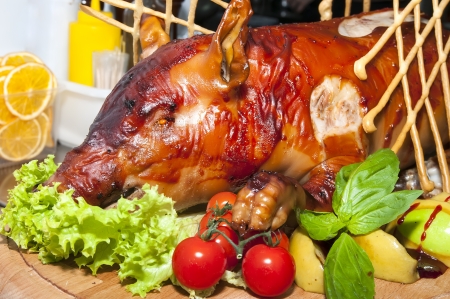 roasted pig with herbs and vegetablesの写真素材