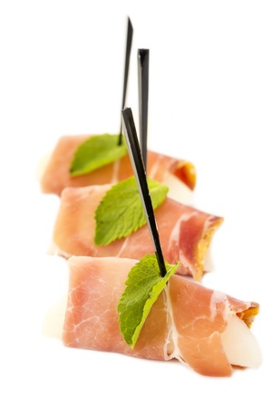 canape with meat seafood and vegetables on a white backgroundの写真素材