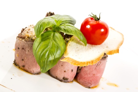 meat rolls with cheese decorated with tomato