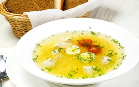 chicken soup on a table at restaurantの写真素材