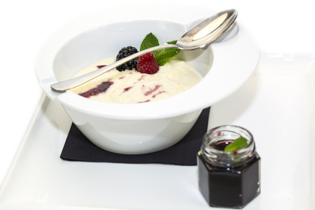 semolina porridge with berries decorated with berry jamの写真素材