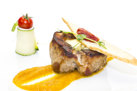 roasted meat with mustard sauce on a white backgroundの写真素材