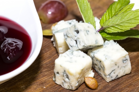 cheese plate with several varieties of cheese in the restaurantの写真素材