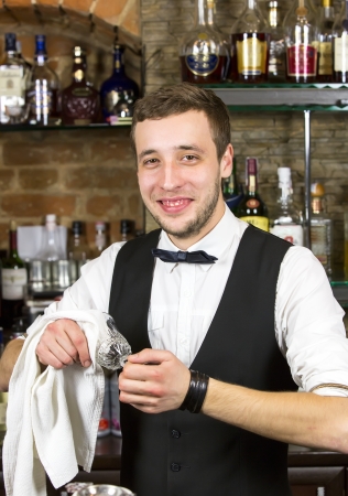 young man working as a bartender in a nightclub barの写真素材