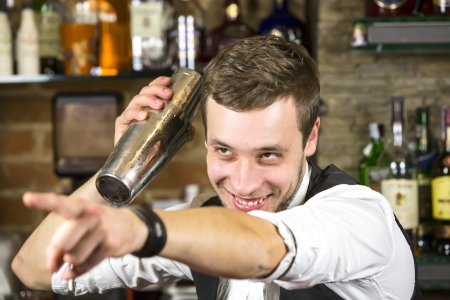 young man working as a bartender in a nightclub barの写真素材