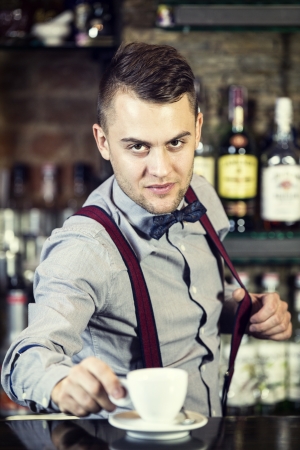 young man working as a bartender in a nightclub barの写真素材