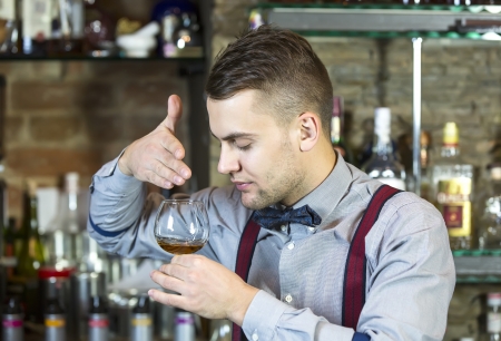 young man working as a bartender in a nightclub barの写真素材