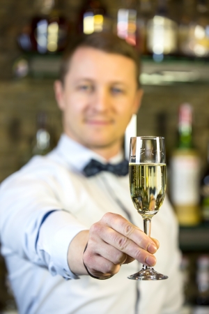 young man working as a bartender in a nightclub barの写真素材