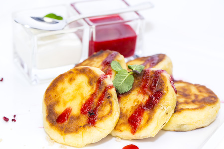 cheese cakes with jam and cream on a white background in the restaurantの写真素材