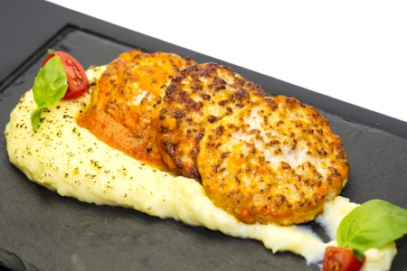 cutlets fried in carrot sauce with mashed potatoesの写真素材