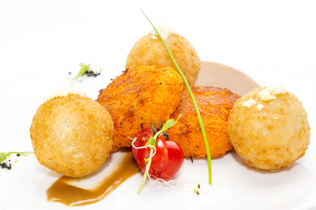 carrot vegetarian meatballs on a white plate in a restaurant