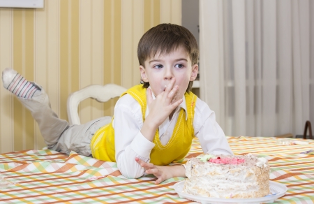kids have fun eating birthday cakeの写真素材