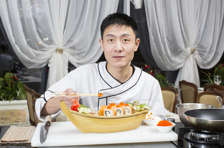 Japanese chef preparing a meal in a restaurantの写真素材
