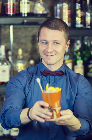 young man working as a bartender in a nightclub barの写真素材