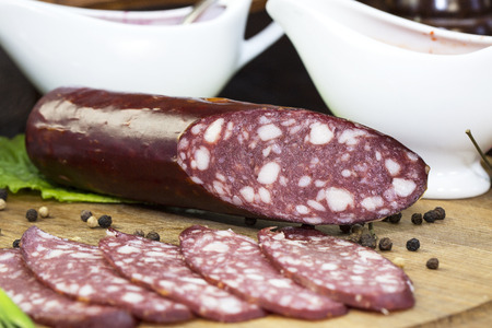 sausage on a wooden plate in a restaurantの写真素材