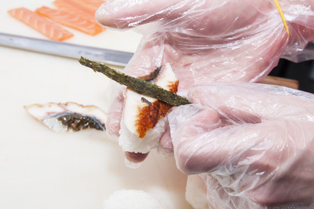 Japanese chef preparing a meal in a restaurantの写真素材