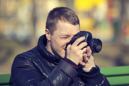 young man photographer photographing nature