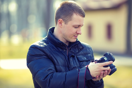 young man photographer photographing nature