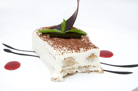 piece of tiramisu cake on a table in a restaurant