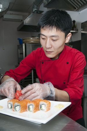 Japanese chef preparing a meal in a restaurantの写真素材