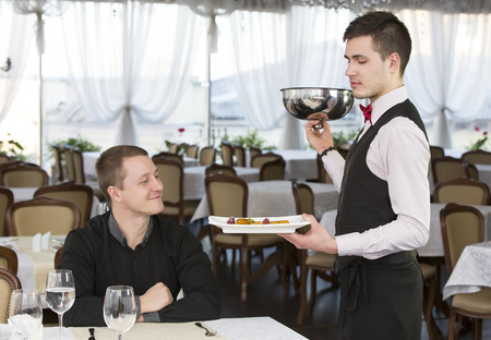 young man having dinner in a restaurantの写真素材