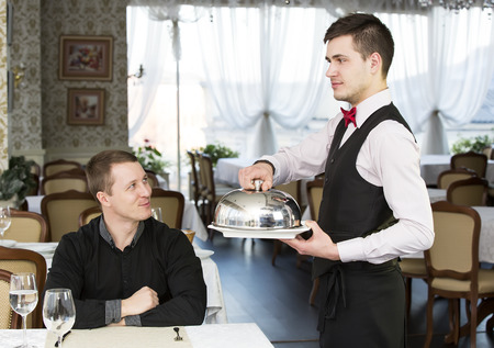 young man having dinner in a restaurantの写真素材