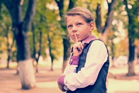 Portrait of a boy on a background of green natureの写真素材