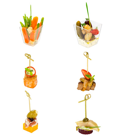 Canapes of cheese vegetables meat and seafood on white backgroundの写真素材