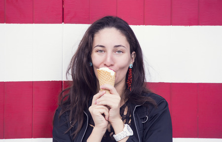 young girl eating an ice cream vanillaの写真素材