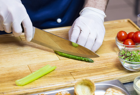 cook prepares canapes in the kitchen at the restaurantの写真素材