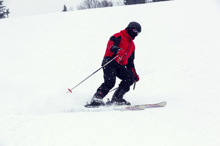 male skier on downhill a steep hillの写真素材