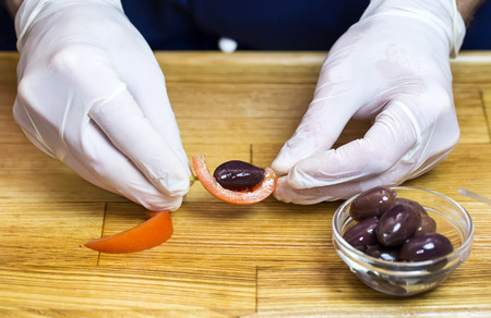 cook prepares canapes in the kitchen at the restaurantの写真素材