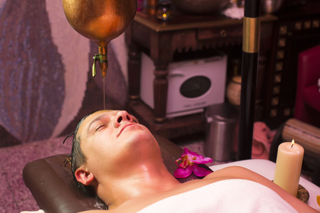 people man engaged in Ayurvedic spa treatmentの写真素材