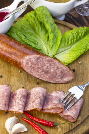 sausage on a wooden plate in a restaurantの写真素材