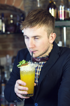 young man working as a bartender in a nightclub barの写真素材