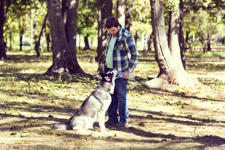 The young man and the Siberian Huskyの写真素材