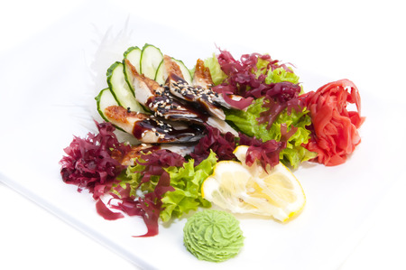 Japanese cuisine sashimi with vegetables and fish in a restaurantの写真素材