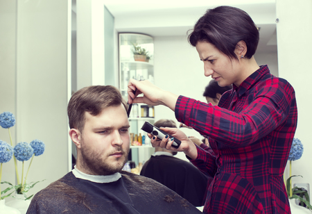 The young man at the hairdresser salon hairstyle make modelの写真素材